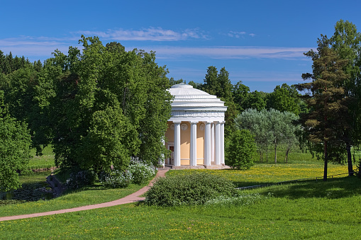 Pavlovsk, Saint Petersburg, Russia - June 2, 2018: Temple of Friendship in Pavlovsk Park. The temple was built in 1781-1784 by design of the Scottish architect Charles Cameron. Pavlovsk Park is a park surrounding the Pavlovsk Palace, the 18th-century Russian Imperial residence built for Emperor Paul I of Russia near Saint Petersburg. Today it is a public park with free access.