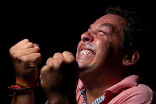 istock Middle-aged dark-haired man wearing a light-colored polo shirt on a black background 1675891577