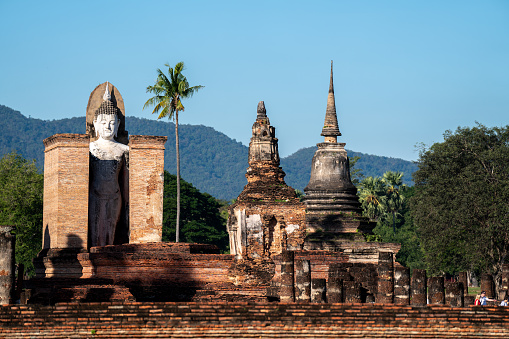 Old statues of Buddhist monks dot the landscape surrounding the Win Sein Taw Ya Buddha of Kyauktalon Taung, near Mawlamyine, Myanmar.