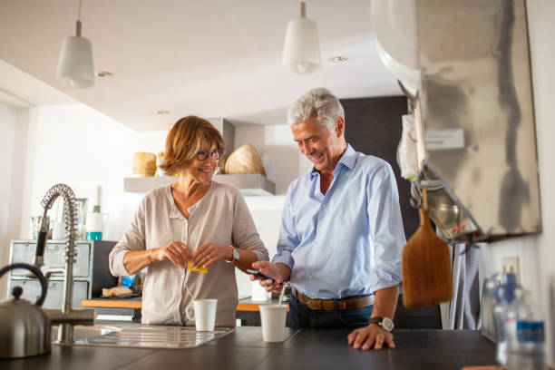 istock happy older couple standing in kitchen together 1675914808