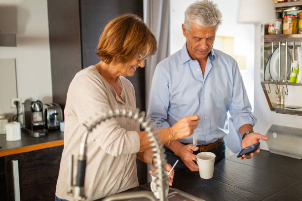 smiling older couple standing in kitchen together