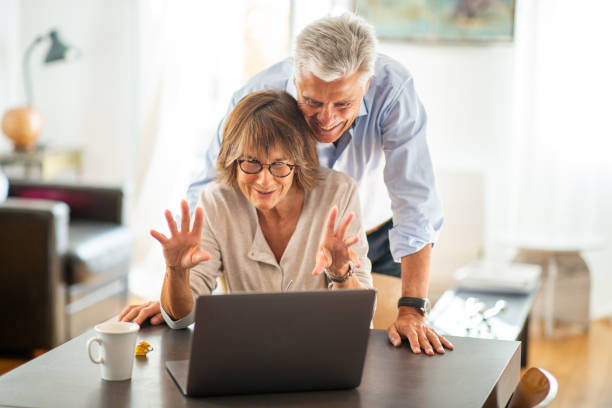 istock happy couple looking at laptop screen during video call 1675915165
