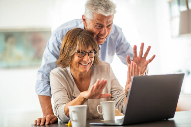 istock happy older couple looking at laptop screen during video call 1675915171