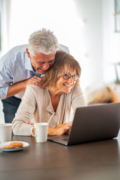 istock happy mature couple by laptop computer 1675915181