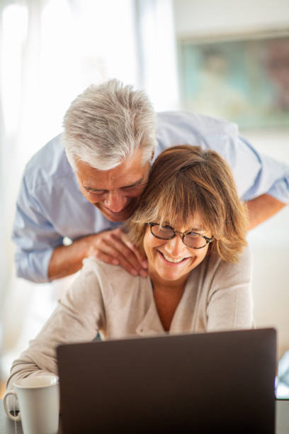 istock smiling couple looking at laptop 1675915194