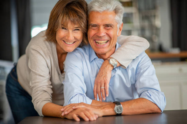 istock Close up smiling older couple sitting at table together 1675915318