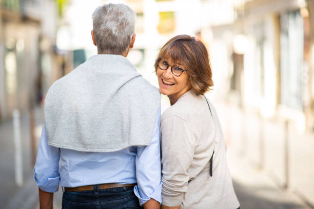 istock behind older couple walking together on street 1675915730