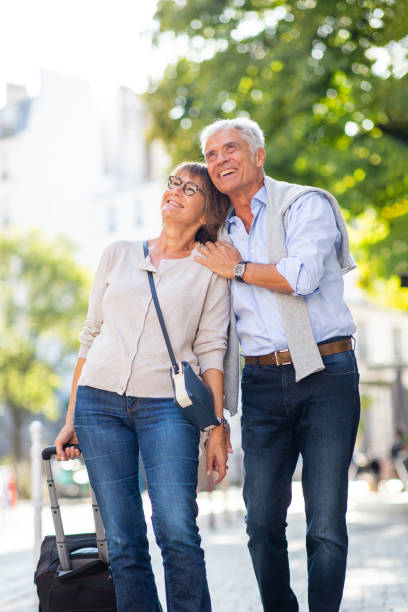 istock happy older couple walking with suitcase 1675915735