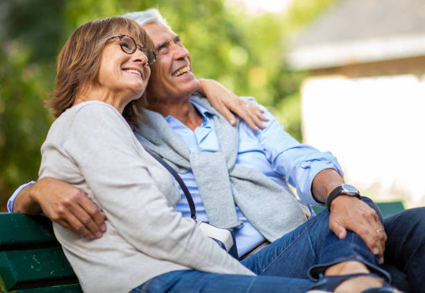 istock Polder happy couple sitting on park bench 1675916300