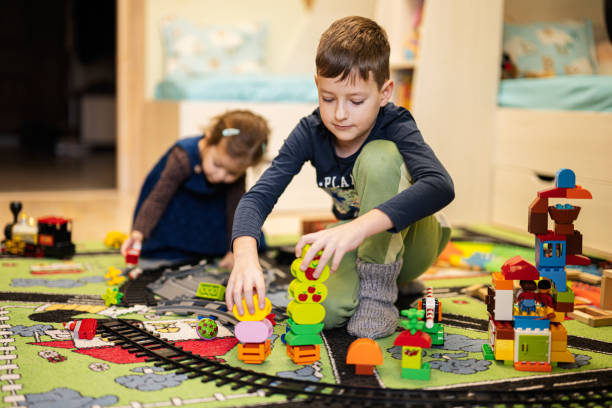 Child leisure activity, creative game. Brother and sister play at home.