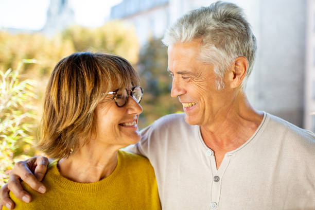 istock Close up smiling older couple looking at each other 1675921369