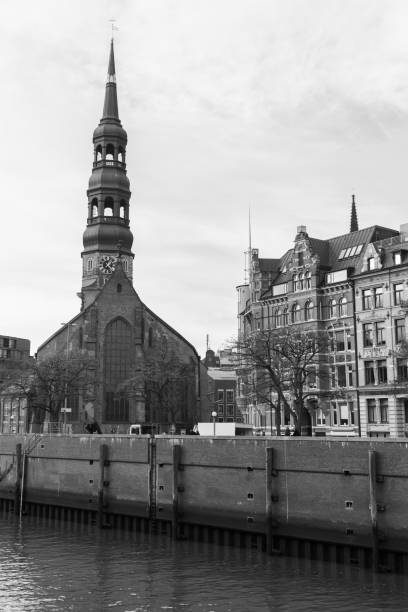 Hamburg old town street view with the St. Catherines Church. Vertical black and white photo