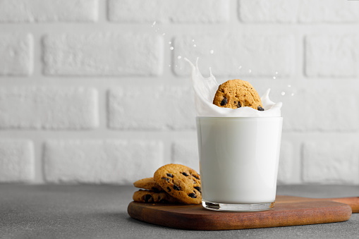 Espresso cup with a cookie on a wooden table.