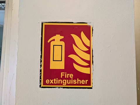 Sign of light fire extinguisher attached to a section of wall