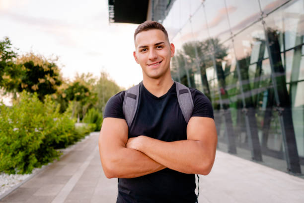istock Young man with a backpack walking home after a workout 1675959889