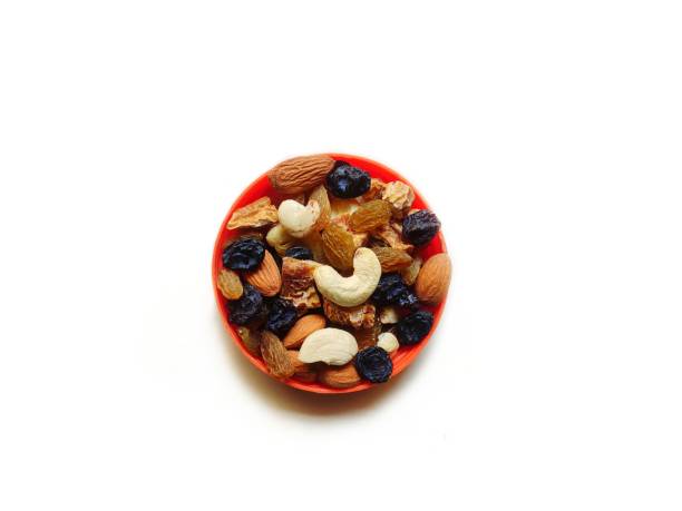 A detailed shot of a glass jar filled with a mix of almonds, walnuts, goji berries, and cranberries, reinforcing a healthy and sustainable diet.