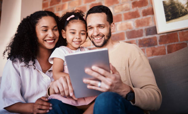 istock Family, tablet and internet on home sofa for e learning, education and time together. A happy man, woman and kid in a lounge with technology for streaming video, movies or games online in Puerto Rico 1675968264