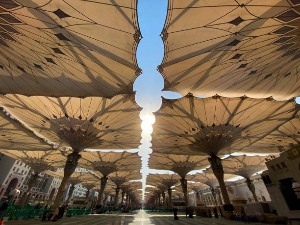 Giant umbrellas at Nabawi Mosque, Medina Saudi Arabia stock photo