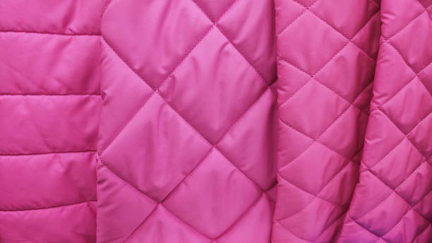 istock Sample of quilted textile pink color close up texture 1675971539
