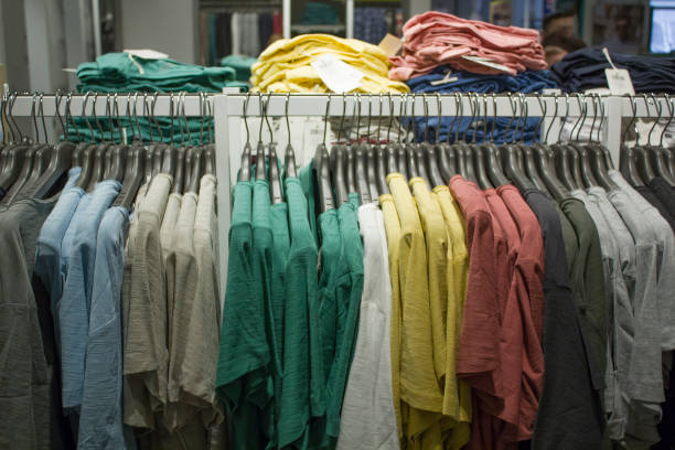 istock Row of rcolorful t-shirts hanging on the hangers in gradient pattern 1675972090