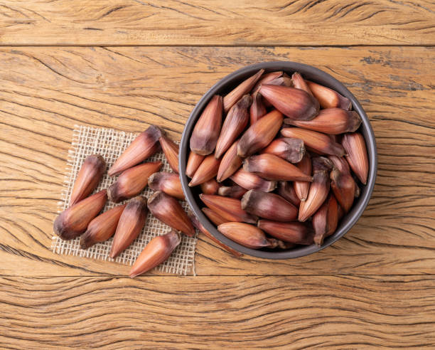 istock Pinions or pine tree seeds on a bowl over wooden table 1675996535