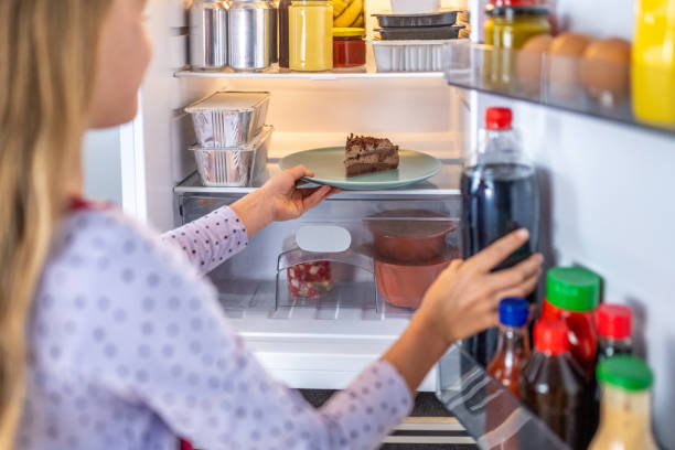 istock Girl takes out cake from refrigerator 1676004174