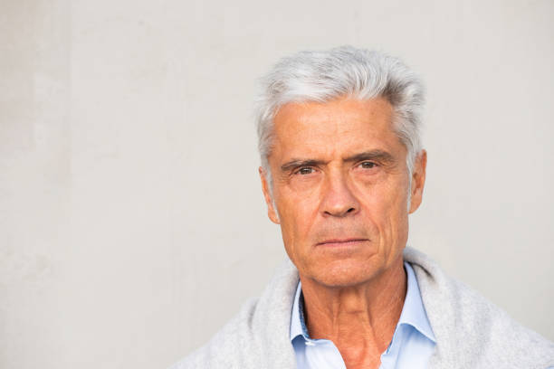 istock Close up portrait serious man against white wall 1676039650