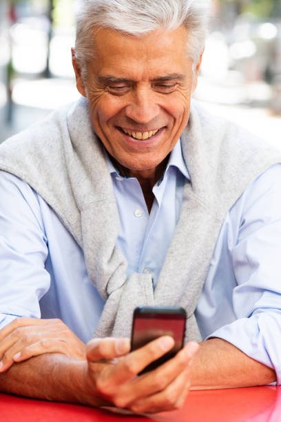 istock Close up older man looking at mobile phone in hand 1676039717