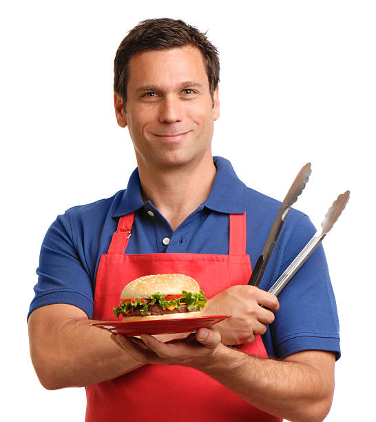 istock Man with Hamburger and barbecue Tongs Isolated on White Background 167604484