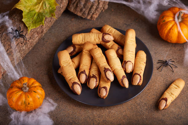 Halloween cookies witch`s fingers with chocolate and almond nuts. Halloween cookies witch`s fingers with chocolate and almond nuts. Delicious and scary dessert for treats. chocolate fingers stock pictures, royalty-free photos & images