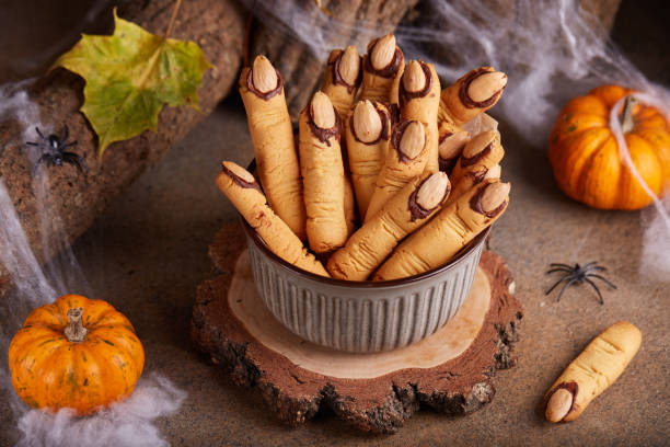 halloween cookies witch`s fingers with chocolate and almond nuts. - witchs imagens e fotografias de stock