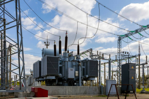 istock Three-phase high-voltage transformer of high electrical power at a substation against the blue sky. 1676063461
