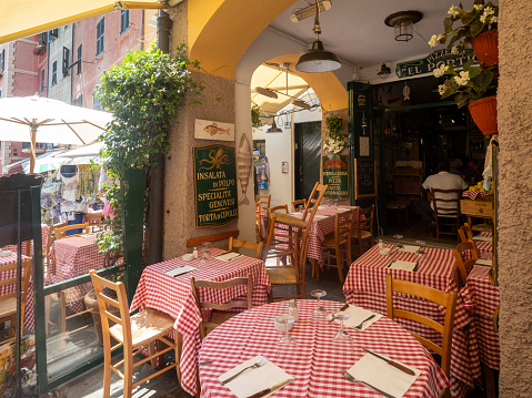 Portofino, Italy - July 05 2023: Restaurant on Via Roma street. Portofino is a comune on the Italian Riviera. Since the late 19th century, Portofino has attracted tourism of the European aristocracy.