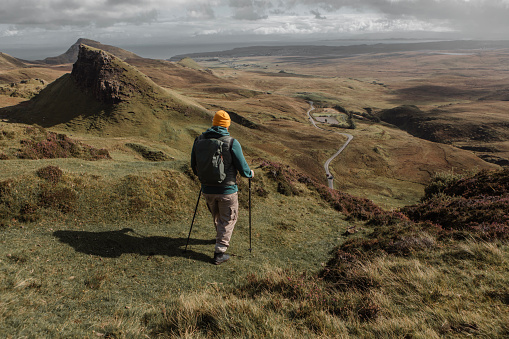 Male hiker enjoying the beautiful countryside landscape of the highlands in Scotland