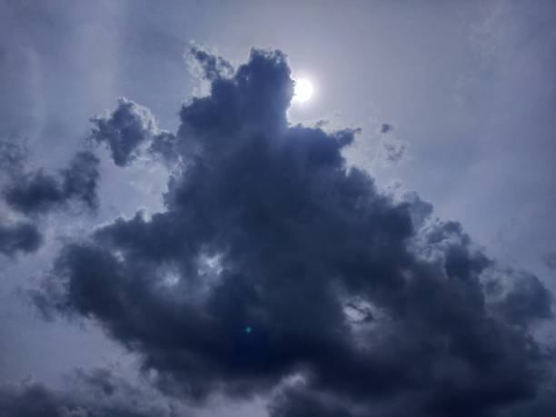 istock Dark Cumulative clouds lookalike Man Standing in the sunny daylight 1676082504