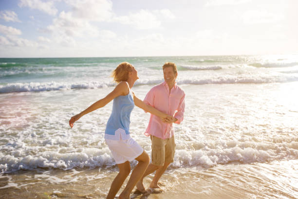 istock Beautiful Happy Mature Couple Having fun on the beach 167608689
