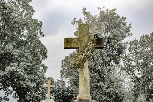 Creepy antique cross in an old cemetery