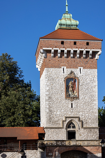 Krakow, Poland - September 6, 2023: Medieval, gothic Florian Gate, part of the city fortifications against Tatar attack. Statue of Saint Florian on facade