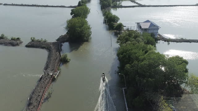 Aerial drone shot of the longtail boat and old wooden bridge
