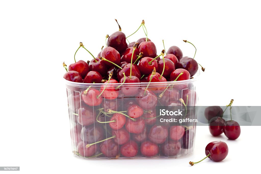red cherries in plastic container red cherries in plastic container on white background Cherry Stock Photo