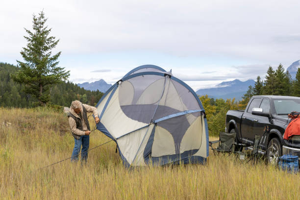 istock Mature man camps in mountain meadow 1676116992