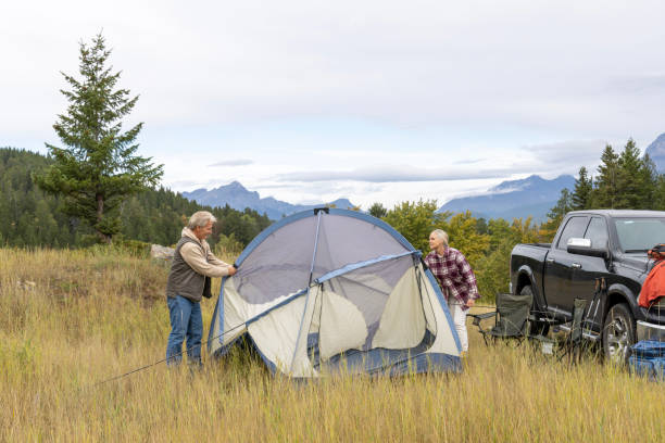 istock Mature couple camp in mountain meadow 1676117000