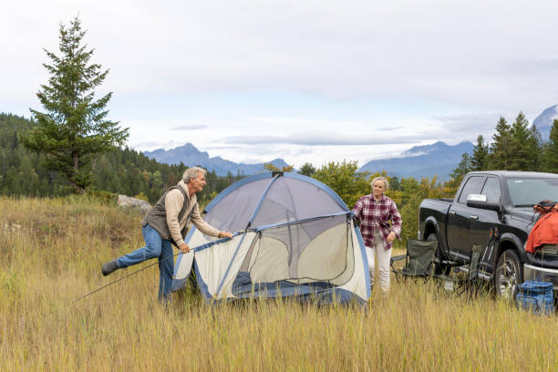 istock Mature couple camp in mountain meadow 1676117001