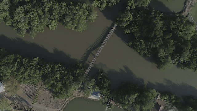 Aerial drone shot of the longtail boat and old wooden bridge