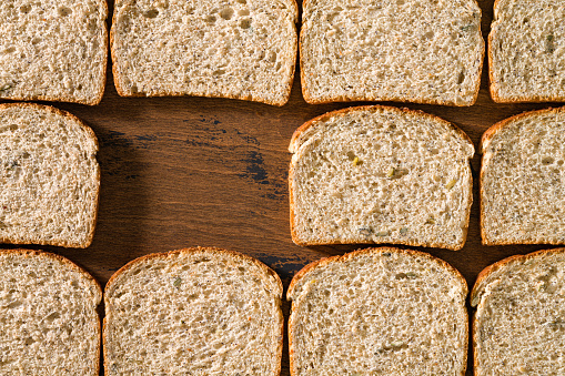Sliced loaf of bread slices in a row flat lay view patern bread backgrounds with copy space blank hole