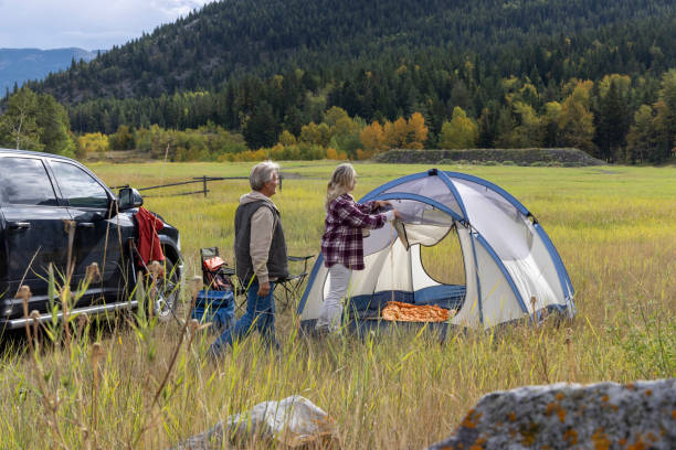 istock Mature couple camp in mountain meadow 1676131059