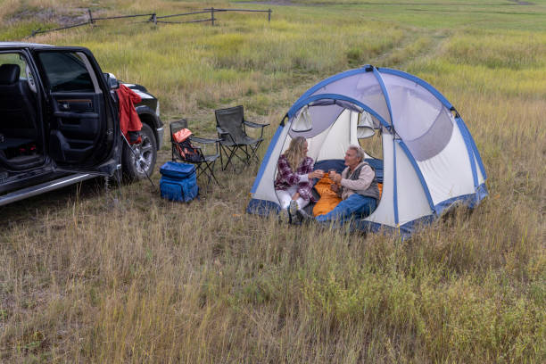 istock Mature couple camp in mountain meadow 1676131291