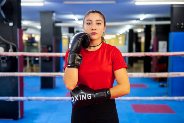 istock Female boxer portrait training with boxing gloves in a ring. 1676133845