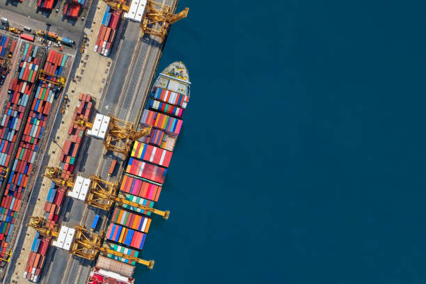 istock Industrial import-export port prepare to load containers. Aerial top view container ship in export and import global business and logistic. Global transportation and logistic business. 1676134374