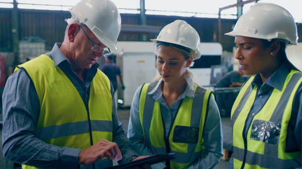 istock Business people, civil engineering and teamwork with a tablet, industrial or planning with digital app. Staff, architecture or group with tech, innovation or conversation with brainstorming or safety 1676137811